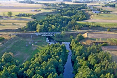 View of the railway bridge and Małe Raczki. Year 2016. Photo Ł. Przychodzki. Widok na most kolejowy oraz miejscowość Małe Raczki. Rok 2016. Fot. Ł. Przychodzki.